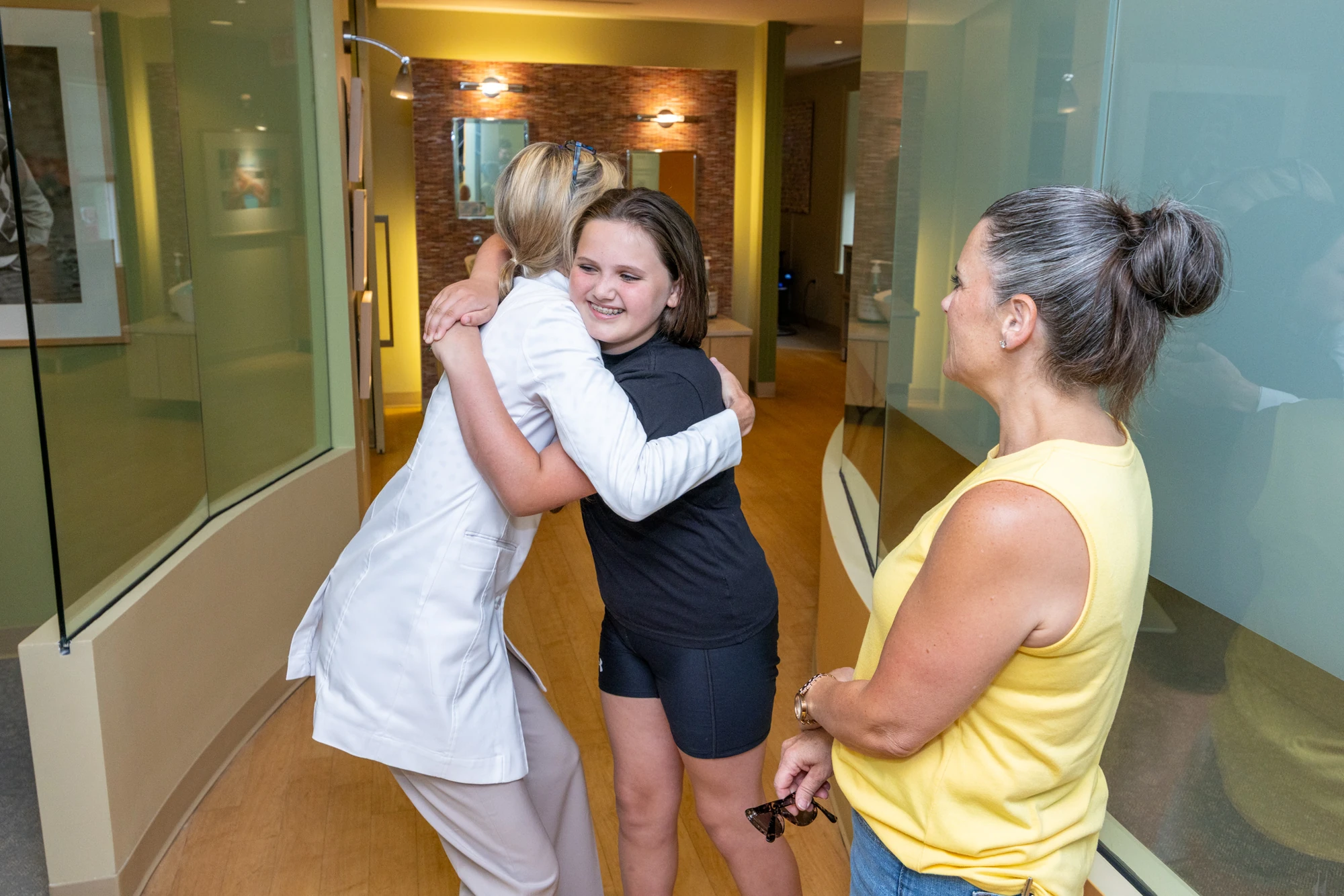 Dr. Cheron hugging a patient after treatment